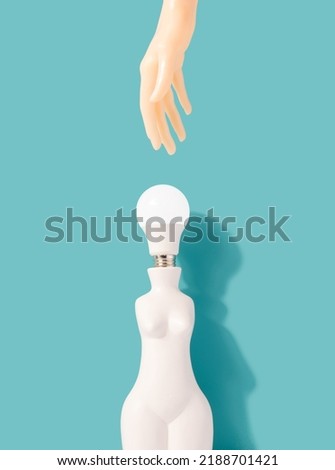 Female shaped vase with light bulb instead of a head with hand reaching. Electricity, power minimal concept.