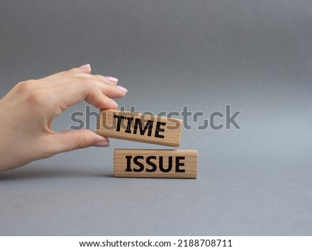 Time issue symbol. Wooden blocks with words Time issue. Beautiful grey background. Businessman hand. Business and Time issue concept. Copy space.