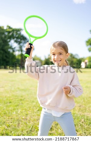 child holding badminton racket in the park, vacation, sport concept. Royalty-Free Stock Photo #2188717867