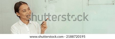 Asian business woman looking on flipboard with charts stand in meeting room. High quality photo