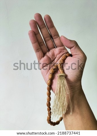 tasbih, made of wood shaped into an ellipse strung on a thread, is used to count dhikr in Islam Royalty-Free Stock Photo #2188737441