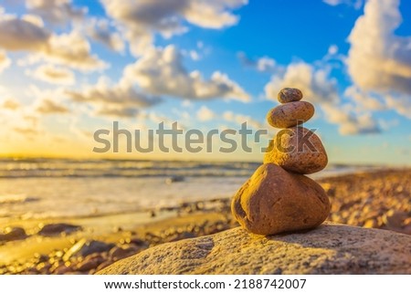 Stone tower on the beach with evening sunset light