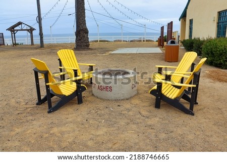 Wooden Adirondack chairs around the fire pit at San Onofre Beach in Camp Pendleton. San Clemente, California, USA.