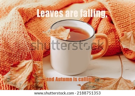 Autumn composition with text . Orange knitted sweater with a cup of tea and autumn leaves