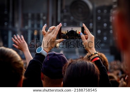 Recording a concert using a mobile phone. Smartphone at music show