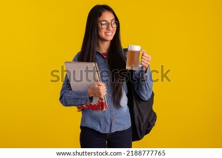 Young adult woman in studio photos making facial expressions and holding a glass of beer