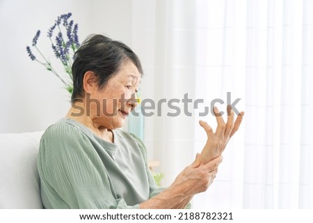 Asian senior woman  having the joint pain at home