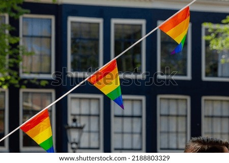 Celebration of pride month in Amsterdam, Rainbow flags hanging outside building along street, Symbol of Gay, Lesbian, Baisexaul and Transgender, LGBT community in Holland, Social movement, Netherlands