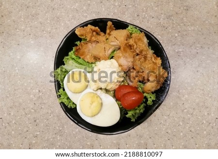 Japanese packed salad, fried chicken , tomatoes, eggs, vegetable and Soy Sauce Chicken, Spicy Paste. Can used on poster, menu, flyers and any media postings. No people on insides.