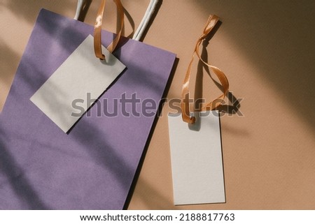 Brand hang tags with empty space for  logo, craft paper bag. Overlay shadows. Label hang tag design, hang tags clothing, swing tag design.