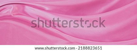 White pink satin texture that is gray silver fabric silk background with beautiful soft blur pattern natural.