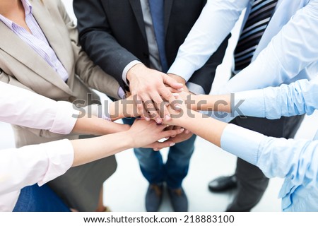 Business people joining hands in circle  Royalty-Free Stock Photo #218883100
