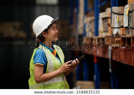 Asian warehouse worker Check stock with tablet and barcode opener. business idea