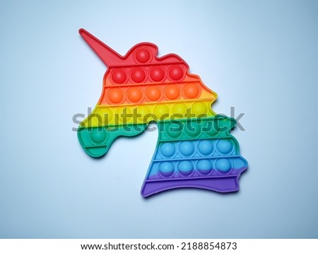 a rainbow-colored children's toy with a picture of a horse's head