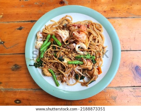 Spicy Spaghetti seafood. thai style.
Spicy spaghetti with shrimp,squid,peper,chili and basil leaf. Food picture.
