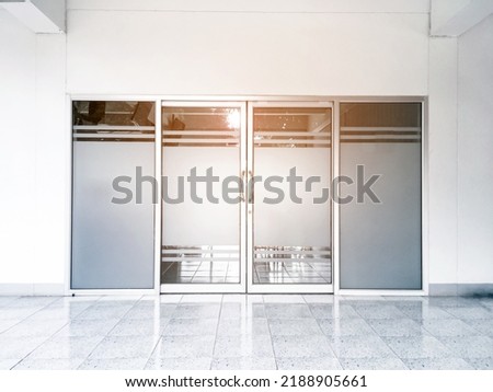 Front doors, glass doors, aluminium door of the store and the office, sunlight edited, soft and selective focus.