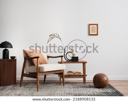 Minimalist composition of elegant living room space with white boucle armchair, photos mock up frames, carpet, coffee table, lamp, decoration and personal accessories. Copy space. Template.  Royalty-Free Stock Photo #2188908135