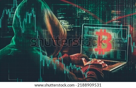 hooded hacker stealing crypto assets  Royalty-Free Stock Photo #2188909531