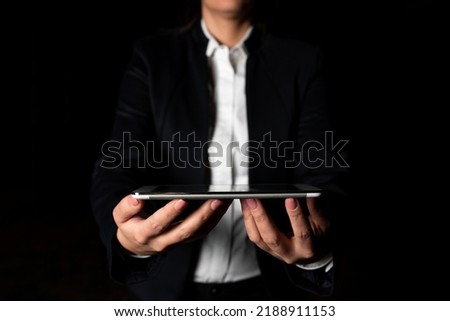 Businesswoman Holding Tablet And Presenting Important Informations. Woman Showing Recent Updates On Screen. Executive Displaying Late Achievements On Cellphone.