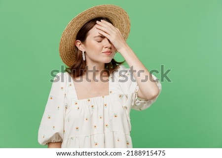 Young sad unhappy woman she 20s wears white dress hat put hand on face facepalm epic fail mistaken omg gesture isolated on plain pastel light green background studio portrait. People lifestyle concept Royalty-Free Stock Photo #2188915475