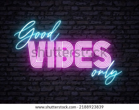 A retro pink and blue colored neon sign - Good Vibes Only - in front of a brick background. Signage for a bar, club or restaurant. Nightlife concept.