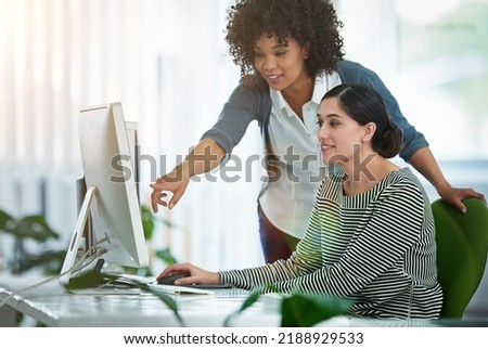 Teaching, training and showing a new employee or intern how business is done as a manager, boss or supervisor. Human resources executive working with a potential hire on a computer in the office Royalty-Free Stock Photo #2188929533