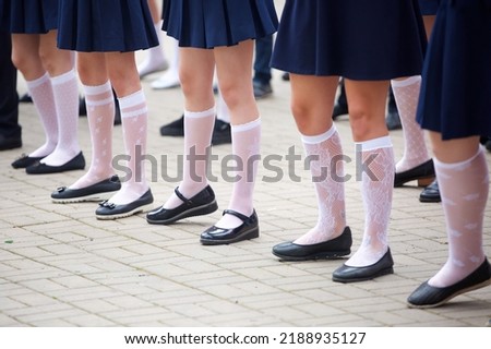 The feet of schoolchildren at the celebration in honor of the beginning of the new school year.