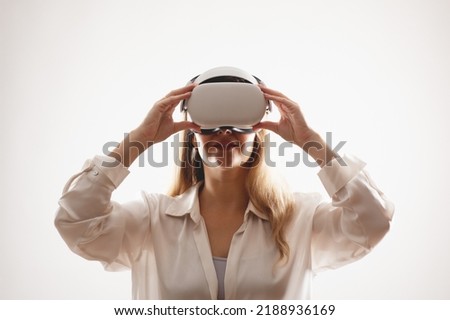 A woman puts on her virtual reality goggles