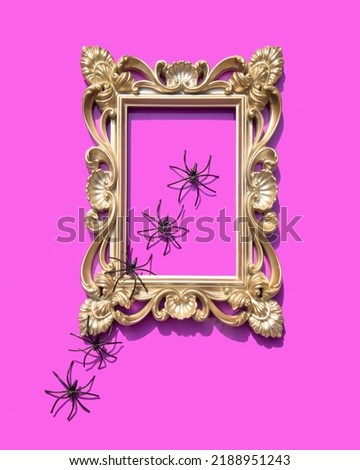 Creative Halloween concept. Scary spiders getting out from picture on pink background. Minimalistic holiday composition.