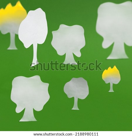 Paper tree on a green background with hard shadows. Pattern. The concept of saving trees, fires in the forest