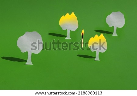 Paper tree on a green background with hard shadows. Pattern. The concept of saving trees, fires in the forest