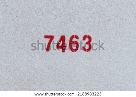 Red Number 7463 on the white wall. Spray paint.
