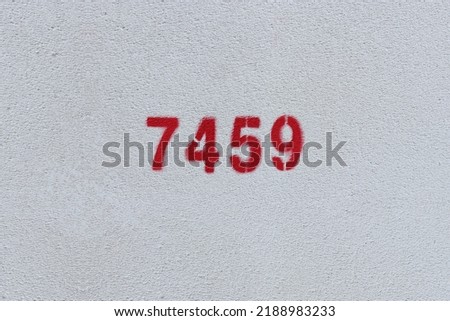 Red Number 7459 on the white wall. Spray paint.
