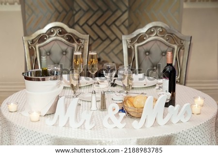           Decorated table in a restaurant at a wedding. Volumetric letters Mr and Mrs at the wedding                      Royalty-Free Stock Photo #2188983785