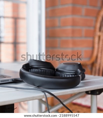 
Headphones for music on the desktop. The concept of music. Close-up. Selective focus. Vertical photo