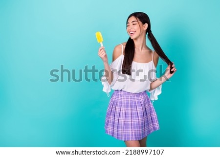 Photo of cute adorable school lady enjoying summer refreshment hold popsicle isolated cyan color background