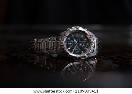 steel waterproof chronograph in water. Swiss watch covered with water droplets Royalty-Free Stock Photo #2189003411