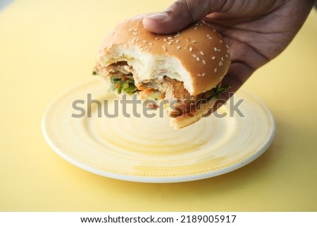  half eaten beef burger on table close up 