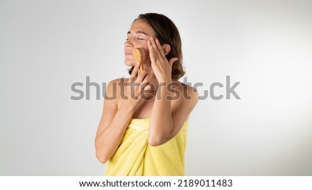 Massage brush on a woman's face - home facial care. High quality photo