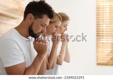 Group of religious people praying together indoors. Space for text Royalty-Free Stock Photo #2189021291