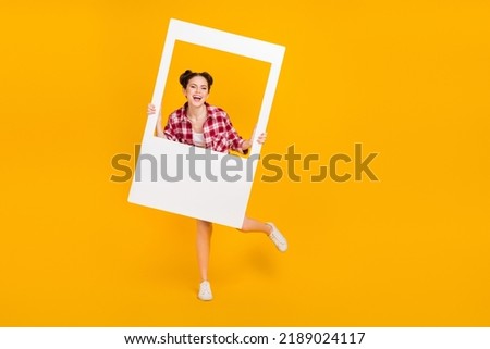 Full size photo of youngster sweet lady hold white photograph border enjoy camera shooting isolated shine color background