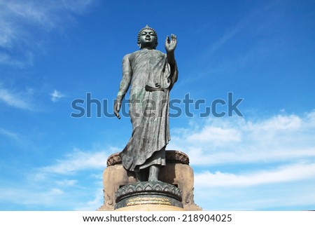 Buddha image standing on blue sky in Thailand 