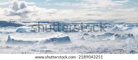 Climate change and global warming. Icebergs from a melting glacier in Ilulissat Glacier, Greenland. The icy landscape of the Arctic nature in the UNESCO world heritage site. Royalty-Free Stock Photo #2189043251