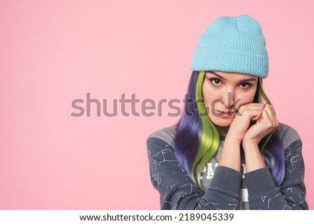 Sad poor young hipster caucasian girl feeling guilty praying begging money looking at camera isolated in pink background