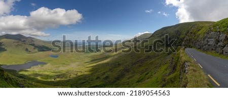 panorama landscape with the steep and winding mountain road leading to the top of Connor Pass on the Dingle Peninsula in County Kerry Royalty-Free Stock Photo #2189054563