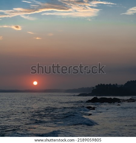The setting sun over the ocean horizon