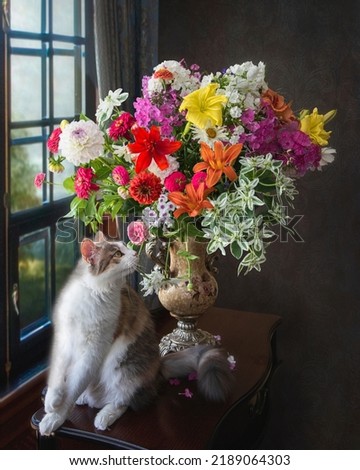 Charming kitty with a bouquet of garden flowers