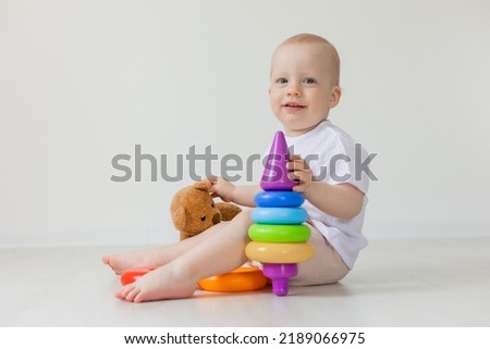 adorable little boy playing with teddy bear on floor, toys, health, banner, card, space for text. High quality photo