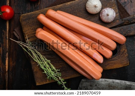 Raw  sausage, on old dark  wooden table background, top view flat lay.