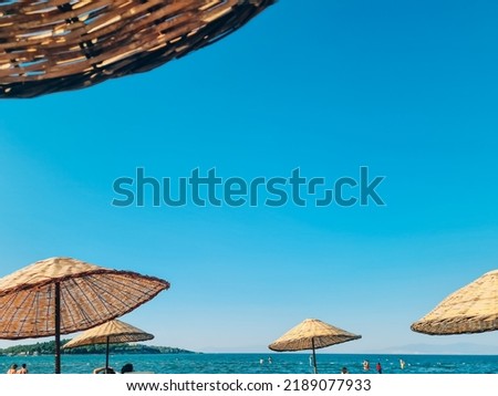 Bamboo beach umbrella on blue sky background